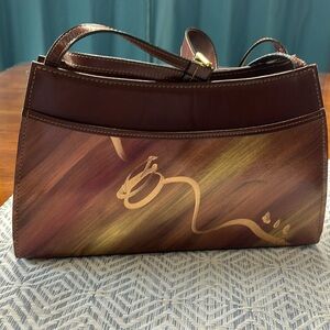 Hand painted handbag with shoulder strap.